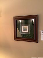 Framed art print titled "Early Fall" by Ingrid Hunt hanging on a wall with dark wooden frame.