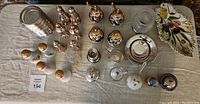 Overview of entire collection of shakers, mills, silver accessories, and tray