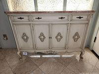 Front view of console cabinet with marble top