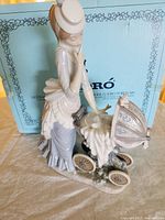 Woman with pram figurine in front of Lladro box