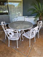 Full set view on patio from angle showing table and chairs