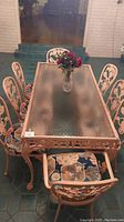Full frontal view of table with all eight chairs and floral centerpiece