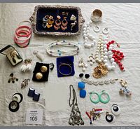 Assorted bracelets, necklaces, earrings and silver tray laid out