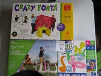 Photo of Crazy Forts box showing 69 pieces and children playing, alongside the Ring Toss set and Balloon Modelling kit boxed items.