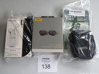 Photo of the Jabra Elite 85t boxed earbuds, Escape wireless earphones boxed, and Roots small camera bag in original packaging.