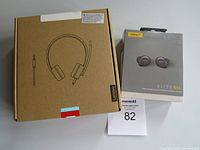 Front view of Lenovo headphones box and Jabra Elite 85t earbuds box, showing product outlines and branding.