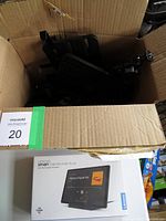 Cardboard box containing sealed tablet box and loose mounting hardware