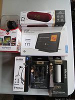 Six boxed electronic items on a table