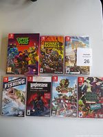 Seven Nintendo Switch game cases displayed on a white surface
