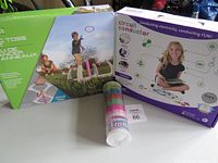 Photo of three items: Circuit Conductor STEM kit box, Ring Toss game box, and a cylindrical container of colorful badminton birdies.