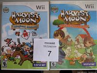 Photo of two Wii game cases: Harvest Moon Magical Melody and Harvest Moon Tree of Tranquility, showing the front cover art and branding.