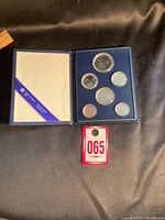 Photo of the open blue presentation case with six 1983 Canadian proof coins in clear capsules.