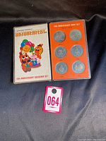 Photo showing the open mint set with 6 coins dated 1973-1978 and original packaging with colorful Oktoberfest cartoon characters.