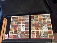 Two vintage Group of Seven art books with colorful slip covers, sized about 11 x 13 inches each, displayed on a black surface beside a ruler for scale.