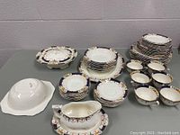 Full overview of all china pieces on table against wall