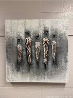 Front view of abstract canvas artwork with five textured vertical forms in brown and white on gray background.