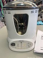 Front view of Black & Decker SmartRotisserie device showing control panel and interior spit holder.