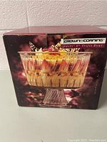 Original box showing image of the Crown Corning swirl design 8-inch trifle bowl filled with dessert.