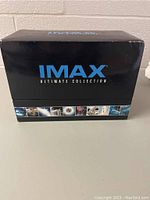 Box set container labeled IMAX Ultimate Collection in black with blue and white text, featuring small image panels related to IMAX content.