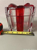 Side view of the clear crystal glass box showing height and thickness with measuring tape