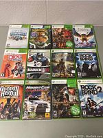 Twelve Xbox 360 game cases arranged in three rows showing front covers featuring Skylanders, Kinectimals, Glee Karaoke Revolution, Madden NFL 07, Elder Scrolls IV Oblivion, Rock Band, Guitar Hero III, Midnight Club, Dragon's Dogma, and Rock Band 2.