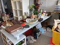 Side view of the folding table with various decorative items placed on top, showing the surface and size.