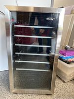 Closed view of the Danby wine fridge showing the front glass door and stainless steel frame.