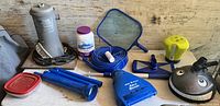 Photo of Intek pool pump, pool cleaning tools including vacuum head, leaf skimmer, chlorine dispenser, blue telescoping pole, bottle of pool chemicals, and other small accessories.