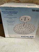 Photo of the boxed Kichler Krystal Ice semi-flushmount ceiling fixture with specifications and model name visible on the packaging.