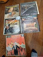 Top view of 5 stereo LP records from the 1960s laid on wooden floor, showing front cover album art for Bert Kaempfert, Roger Williams, Boston Symphony, Mantovani