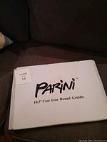 Closed white box labeled 'Parini 10.5'' Cast Iron Round Griddle'