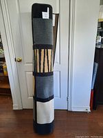 Rolled up view of the rug showing color blocks and patterns.