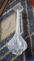 Full view of the frosted stem and bulbous bottom bud shape of the Lalique vase.