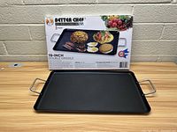Photo of Better Chef 19-inch double griddle and its packaging, showing the griddle flat with metal handles on wooden surface.