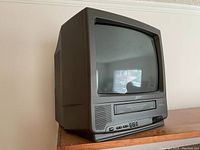 Front angle view showing the full 13-inch Zenith color TV with integrated VHS player sitting on a wooden surface.
