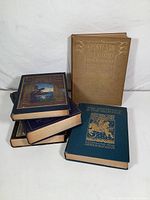 Photo showing five vintage illustrated books stacked and displayed with two covers visible: Stories from Hans Anderson and The Rhinegold & The Valkyrie.