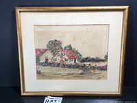 Full view of framed watercolor and collage artwork depicting a cottage and garden scene with postage stamps layered for texture.
