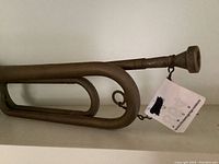 Side view showing the design of the Gretsch bugle, its coiled tubing, and mouthpiece