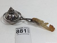 Angle view of lighter showing gyroscope frame and jade handle