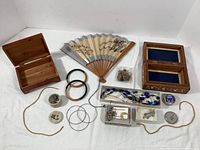 Full lot including Asian fan, wooden jewelry boxes, assorted jewelry pieces, buttons, and Seagull Pewter items spread out on white surface