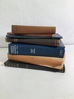 Stack of seven vintage books related to ships, sailing, and maritime history, showing spines and covers with titles and publication details.