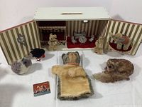 Open dollhouse showing furniture layout and plush animals