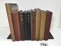 Overall lot photo of 9 early 1900s books including one with dust jacket titled The Magical Monarch of Mo
