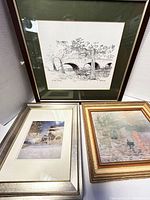 Overall view of the three framed art pieces showing composition and framing details.