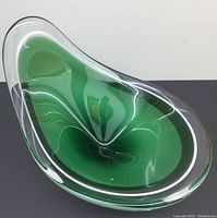 Top-down view showing the green and clear layered glass with an organic asymmetrical, flowing form.