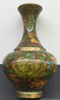 Front view of the vintage cloisonné vase showing floral enamel design on metal body and neck.