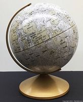 Full view of the vintage tin moon globe on gold metal stand showing detailed lunar surface