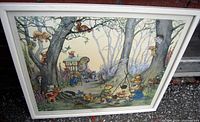 Framed print showing a teddy bears picnic scene with multiple bears and woodland animals beneath large trees in a natural forest setting.