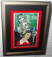 Framed Russian expressionist movie poster with red and black mat in a silver frame.