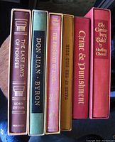 Spines of the six hardcover books showing titles and Heritage Press branding